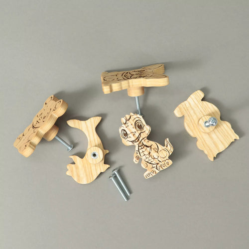 Knobs in solid ash lying on a grey background with the mounting screws