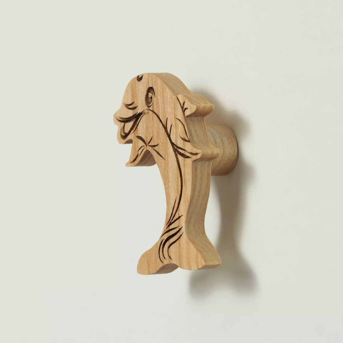 Dolphin cabinet knob in solid ash, engraved and cut to the outline of the animal