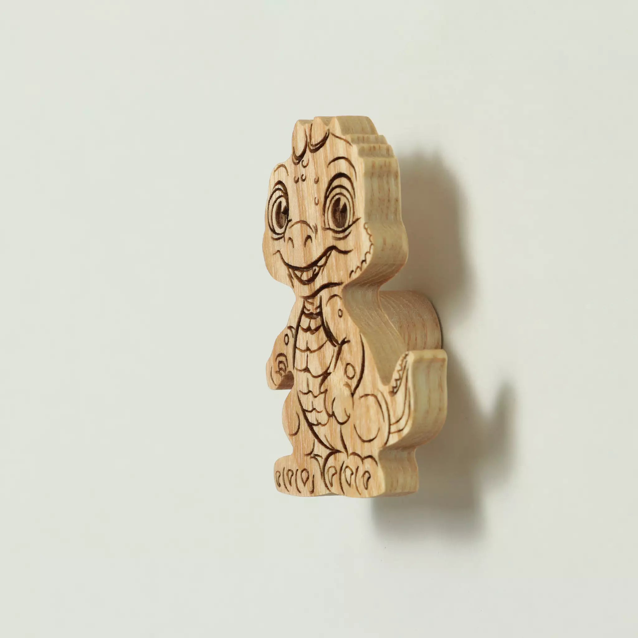 Baby dragon cabinet knob in solid ash, engraved and cut to the outline of the character