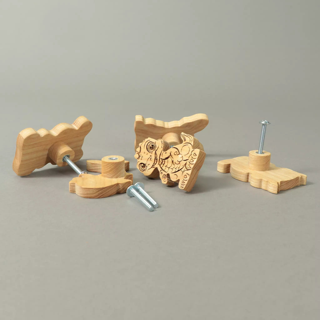 Baby dragon and other ash knobs on a grey background with a mounting screw fitted
