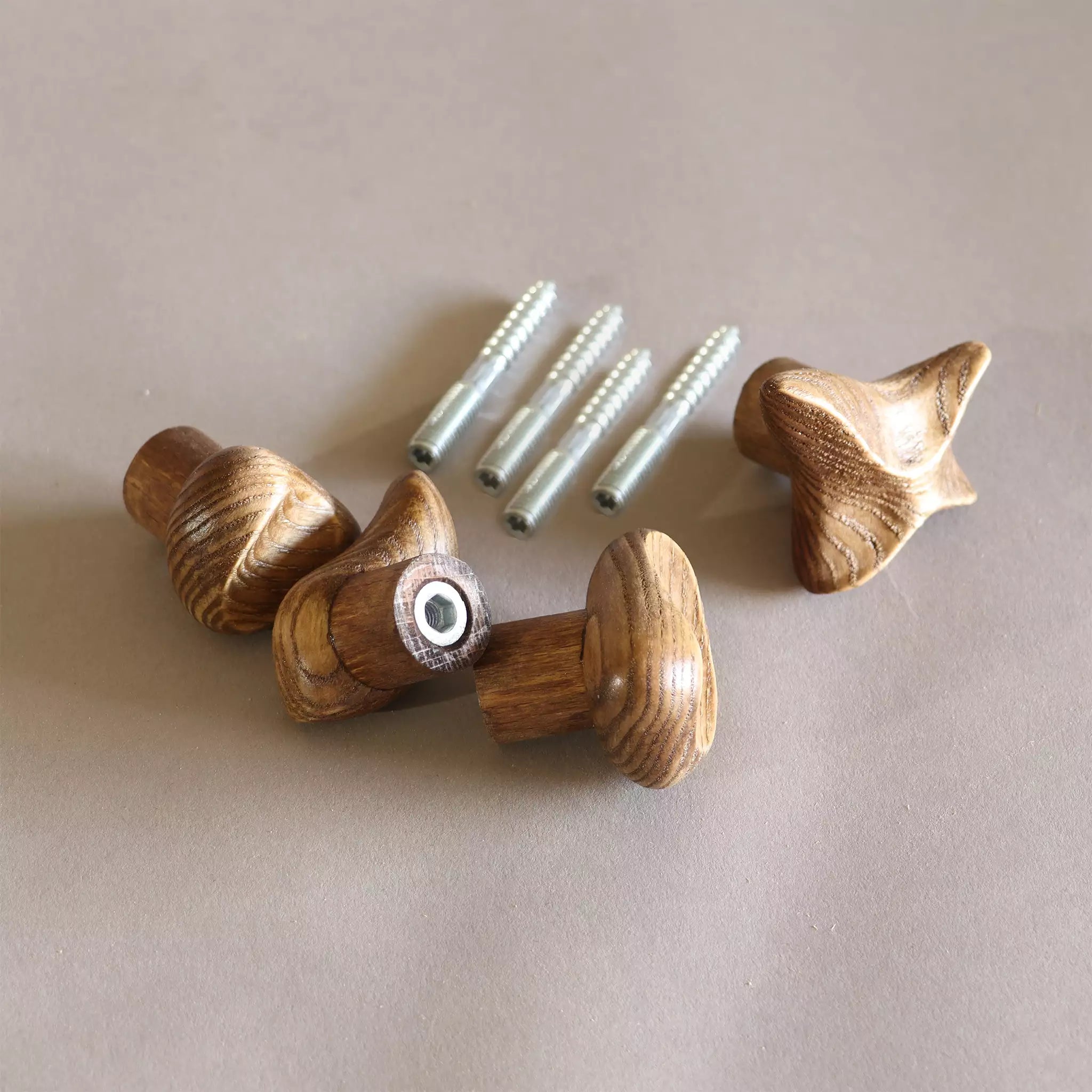 The hooks laid out with the four screws supplied, showing what comes in the package