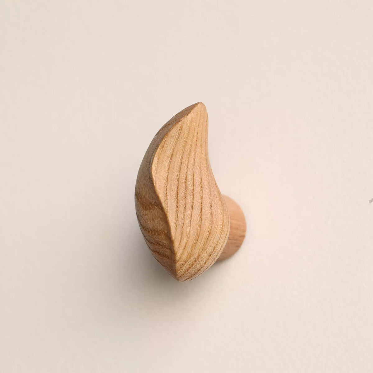 Crescent hook in the natural finish, showing how the shape leans away from the wall
