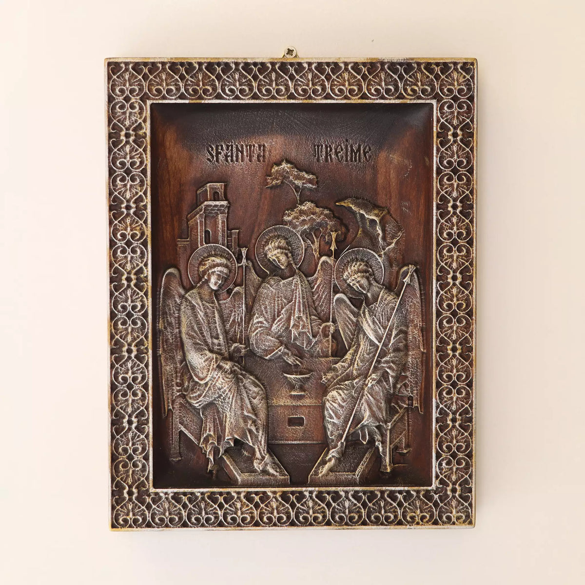The icon hanging flat on a wall, with the metal hanger visible at the top