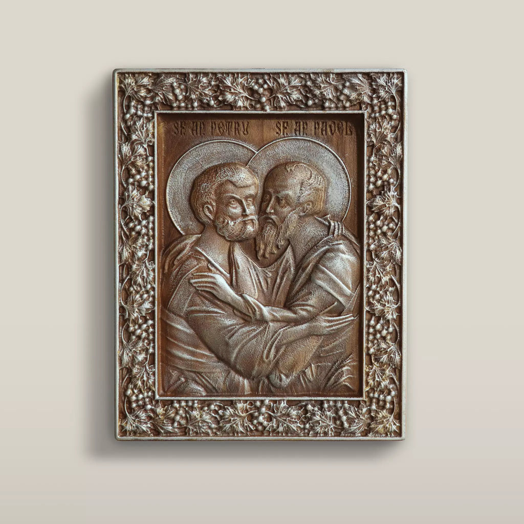 Carved wooden icon of Saints Peter and Paul embracing, framed by a pierced floral border