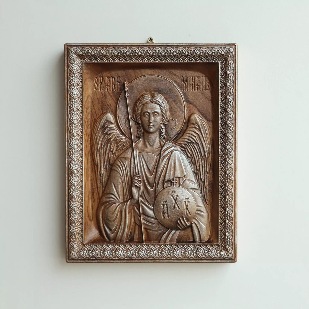 Carved wood icon of the Archangel Michael seen straight on, showing the carved frame and the Romanian inscription