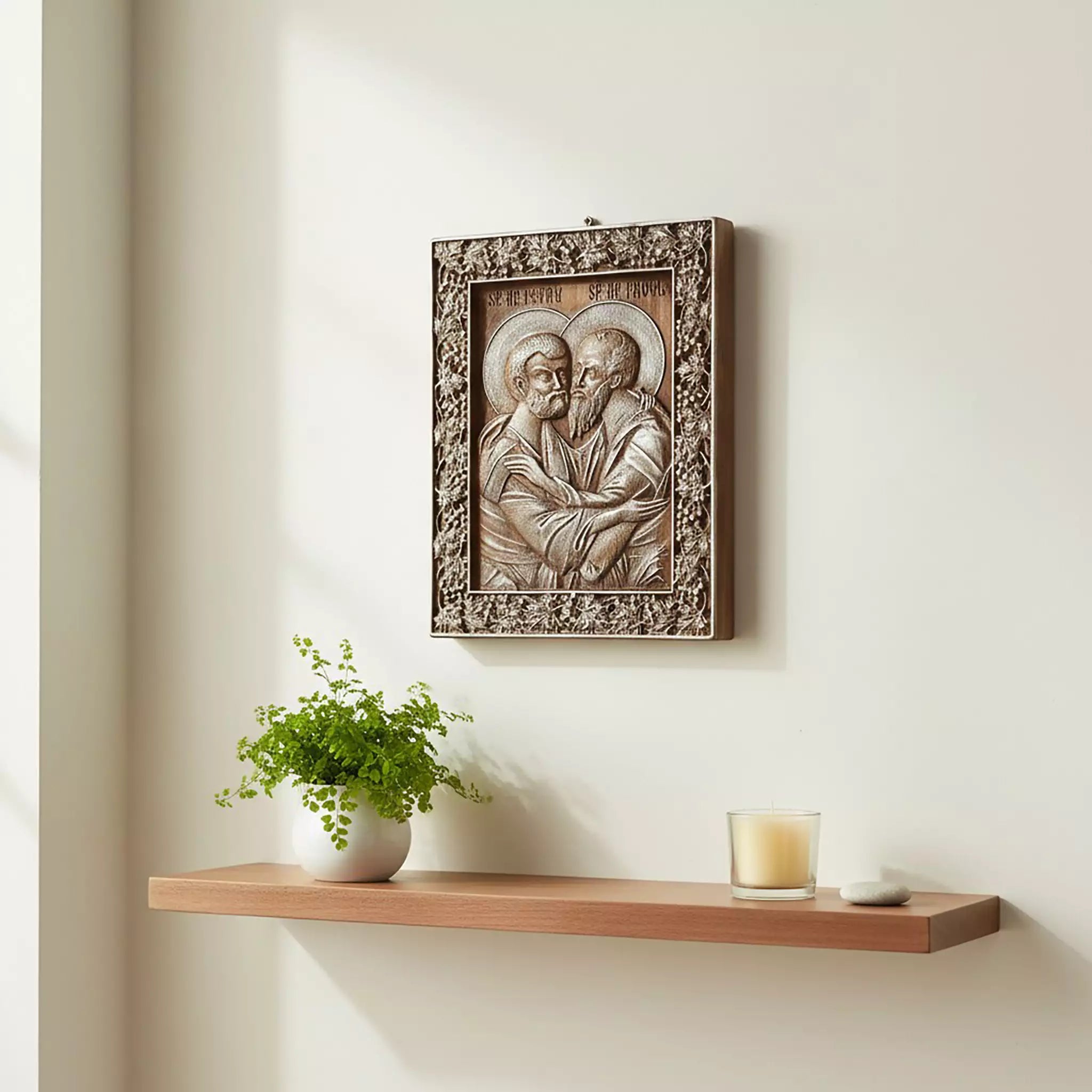 The icon hung above a floating shelf with a plant and a candle