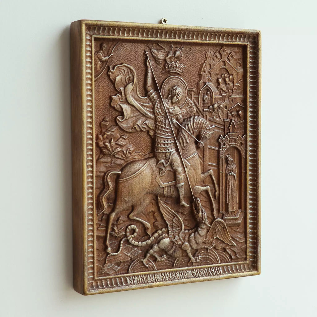 The icon seen at an angle on a white wall, showing the depth of the carved scene