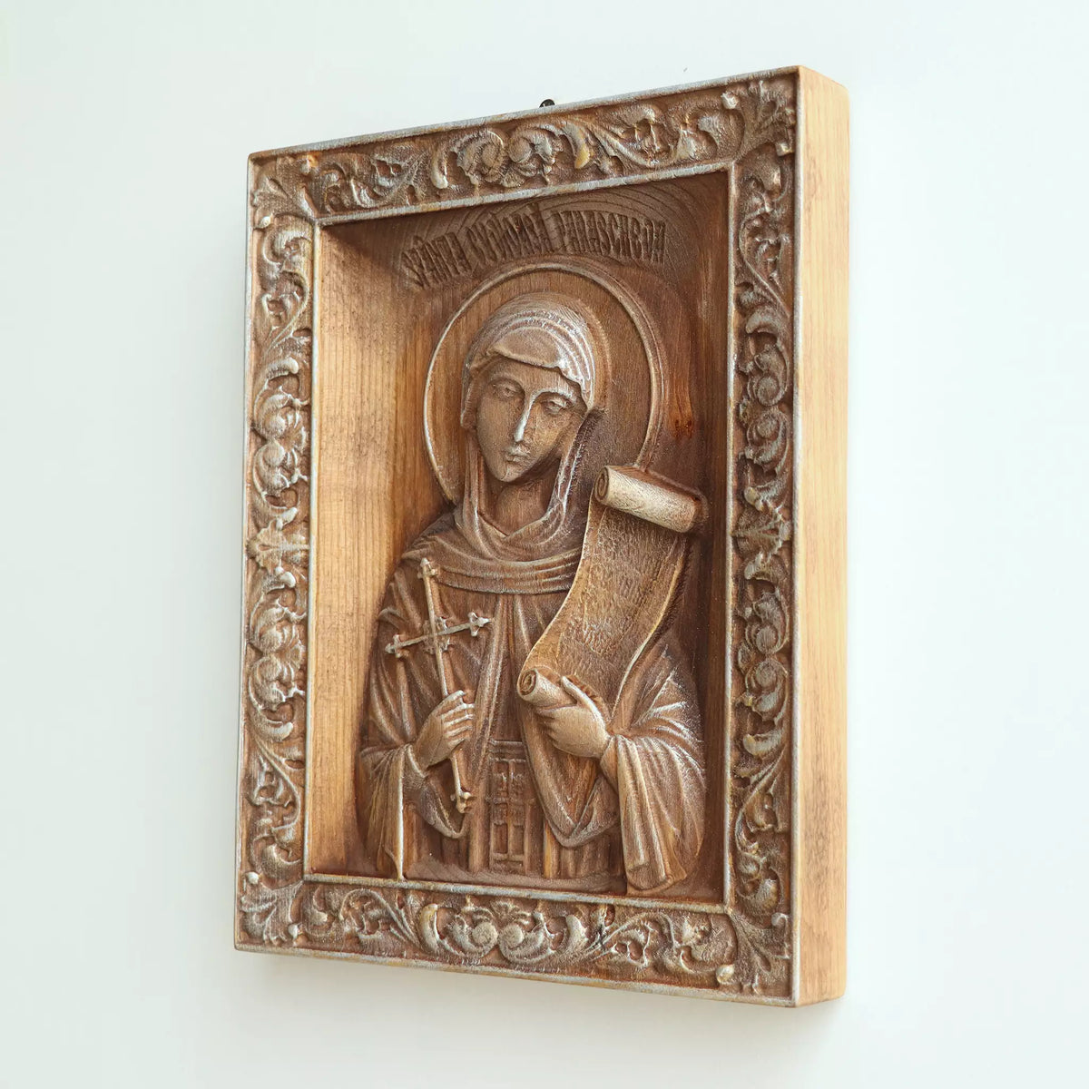 Side view of the icon, showing the thickness of the panel and the pale wood edge