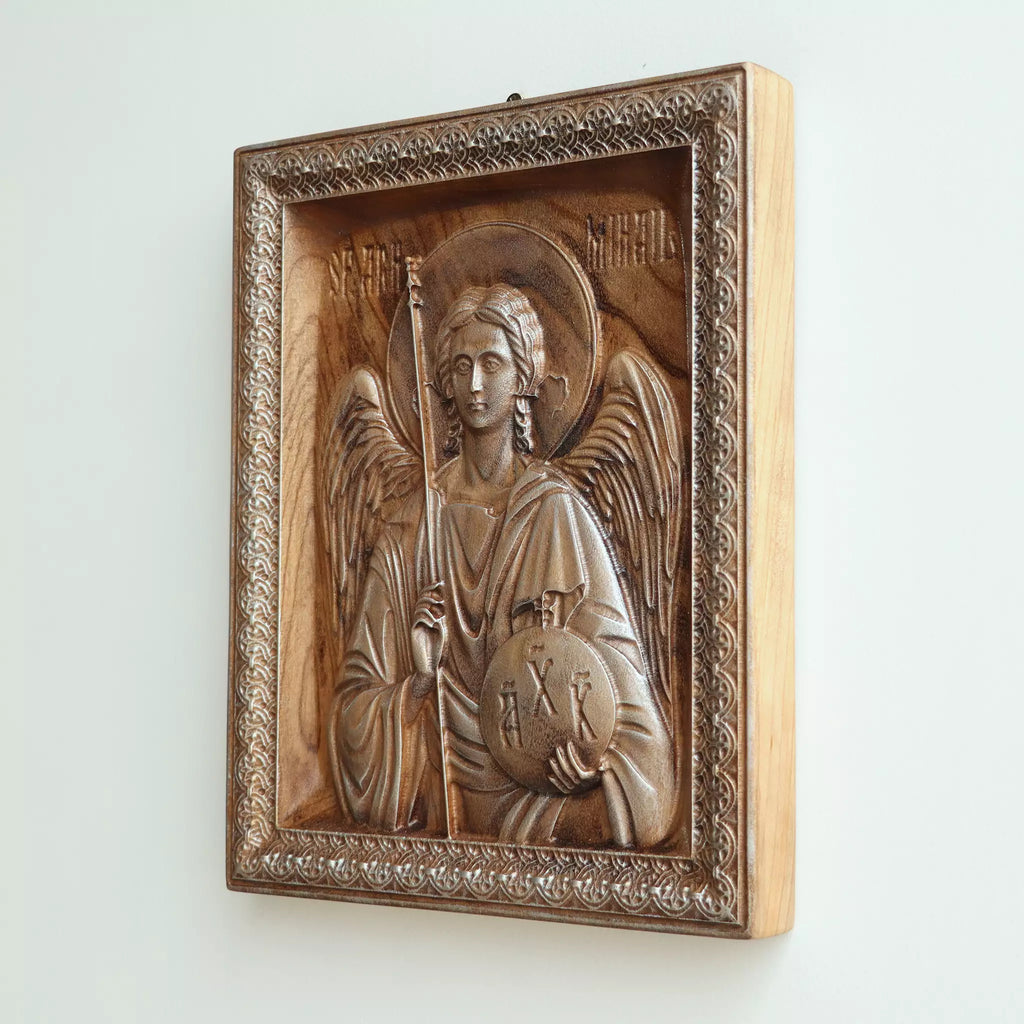 Carved wood icon of the Archangel Michael seen from the side, showing the depth of the relief and the thickness of the panel