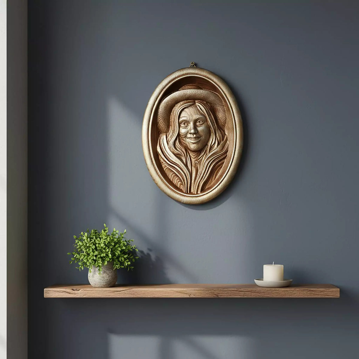 The portrait hung on a dark blue wall above a floating shelf with a plant and a candle