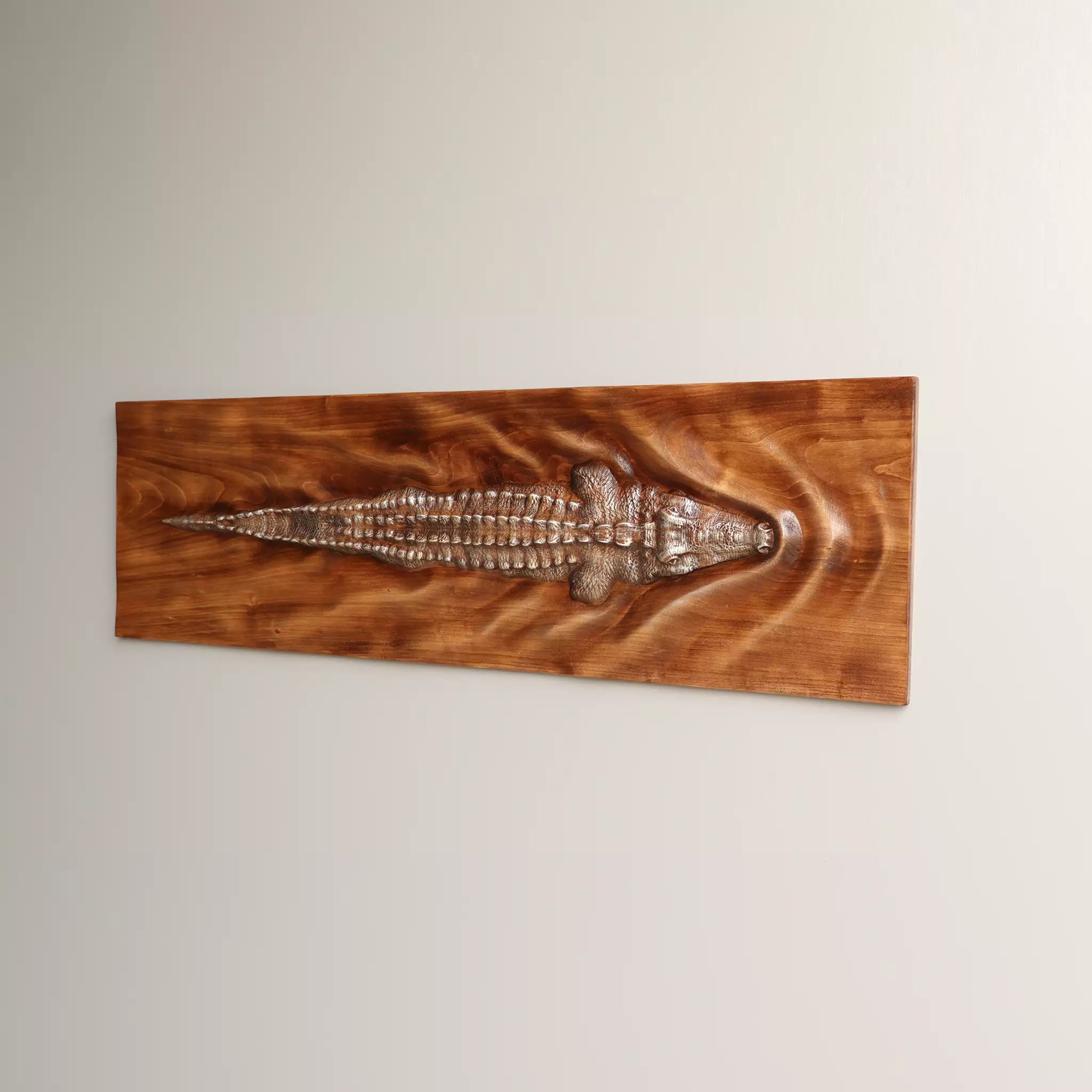 The horizontal panel seen from the other side, showing the carved tail
