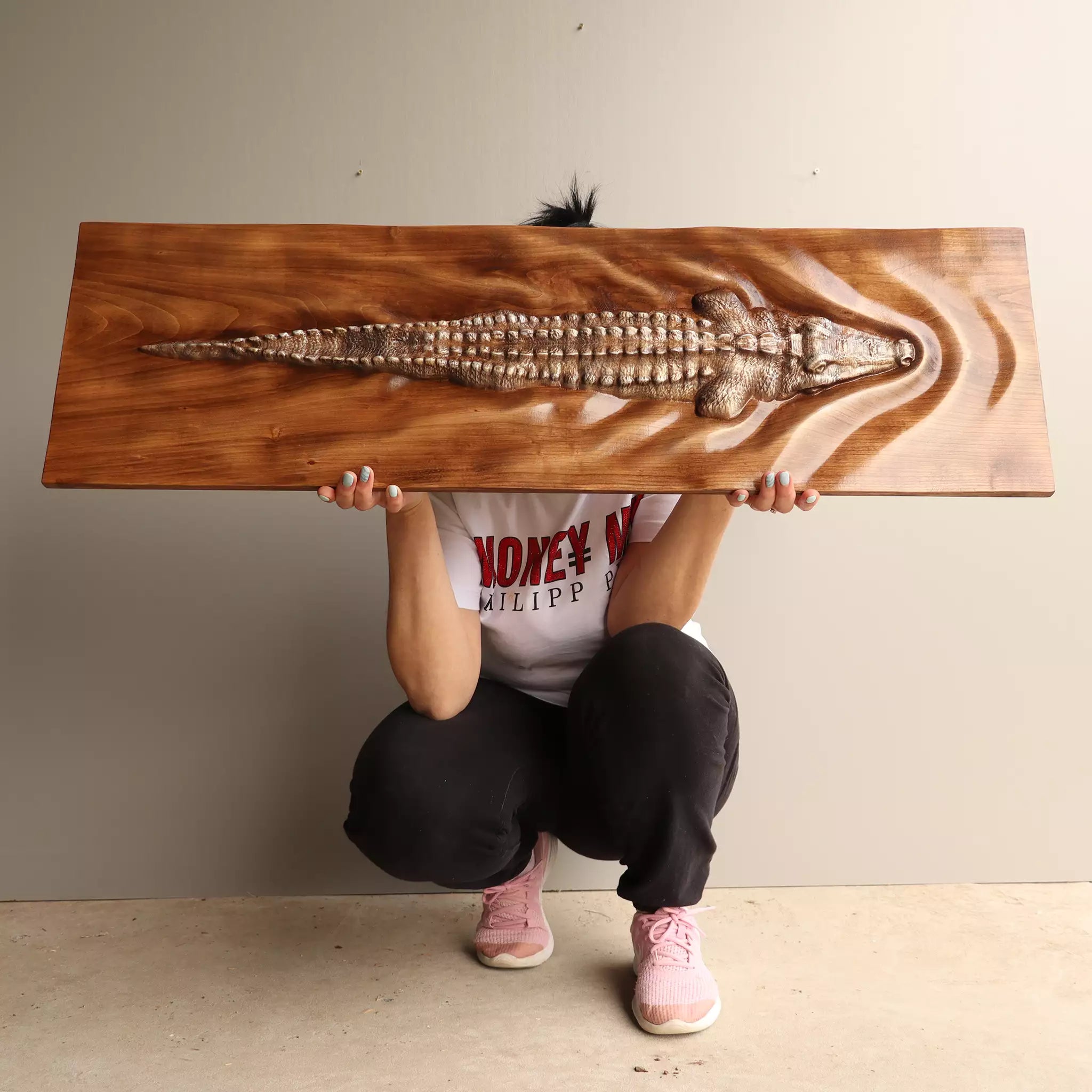 A person holding the panel horizontally, showing its size against an adult