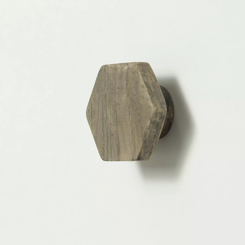 Hexagon cabinet knob in the Dark Gray finish seen from the side, with the base visible behind it