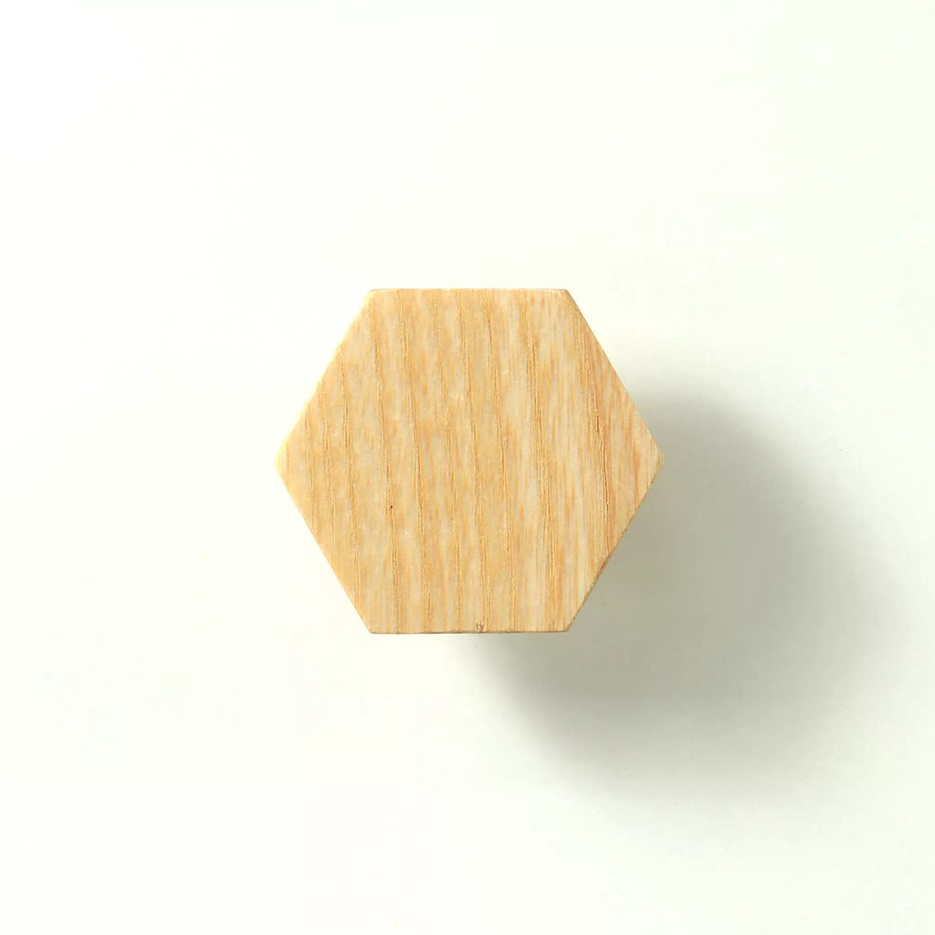 Unfinished solid ash hexagon cabinet knob seen from the front, showing the flat face and six straight sides