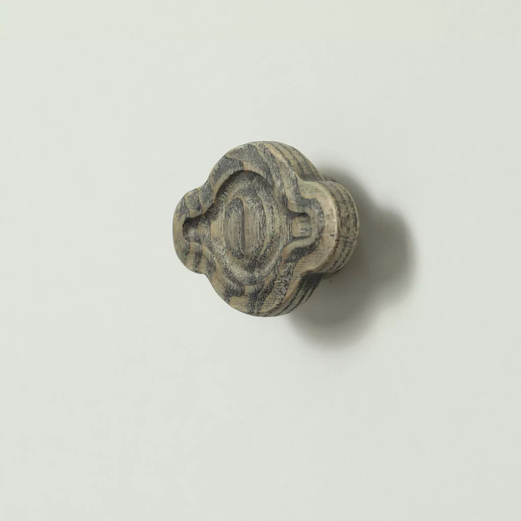 Petal cabinet knob in the Dark Gray finish seen at an angle, with the base visible behind it