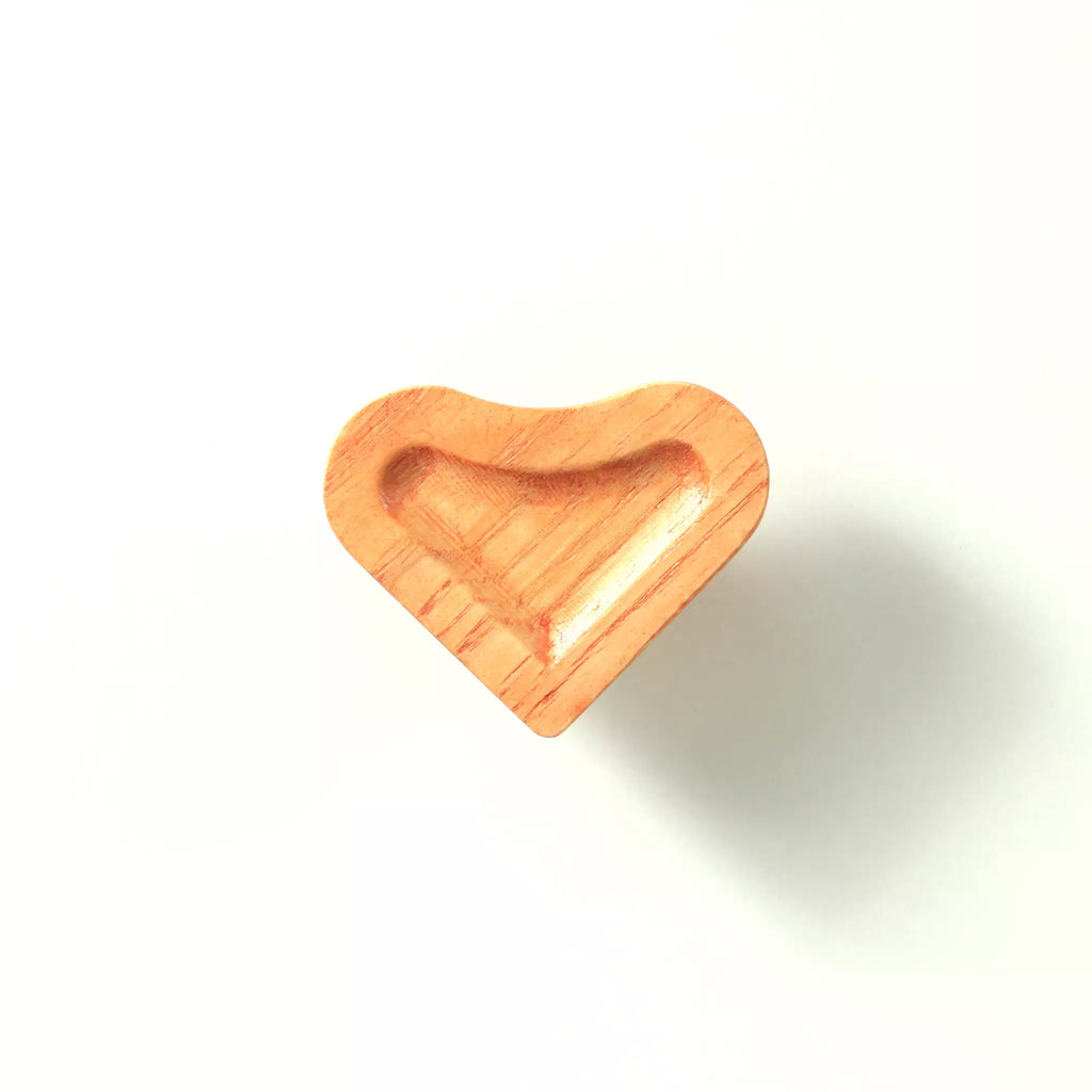 Scooped heart cabinet knob in the Orange finish on a white background, showing the deep carved scoop