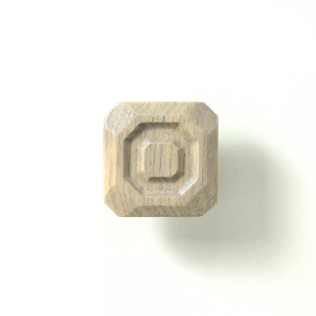 Stepped octagon cabinet knob in the Dark Gray finish on a white background, showing the three tiers