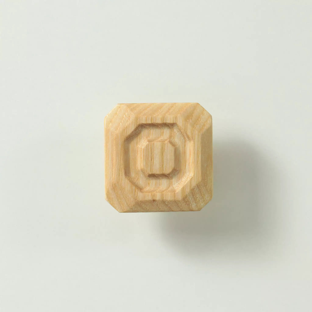 Unfinished solid ash stepped octagon cabinet knob seen from the front, showing the three tiers cut into the face