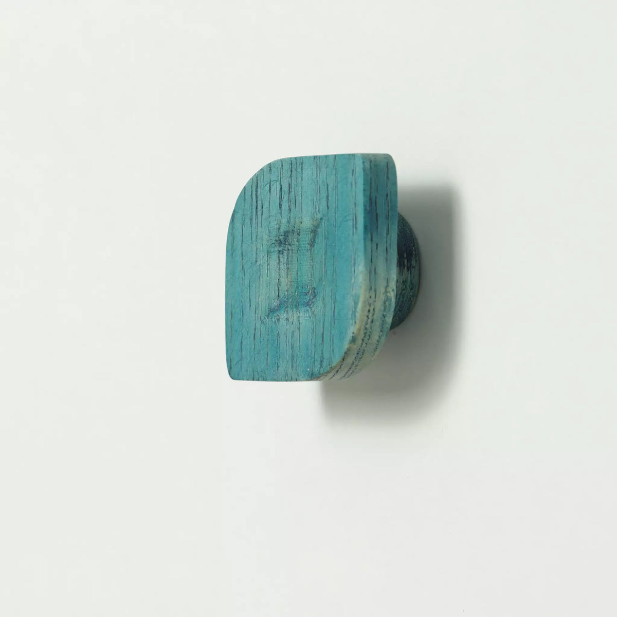 Twist cabinet knob in the Blue finish seen from the side, with the base visible behind it