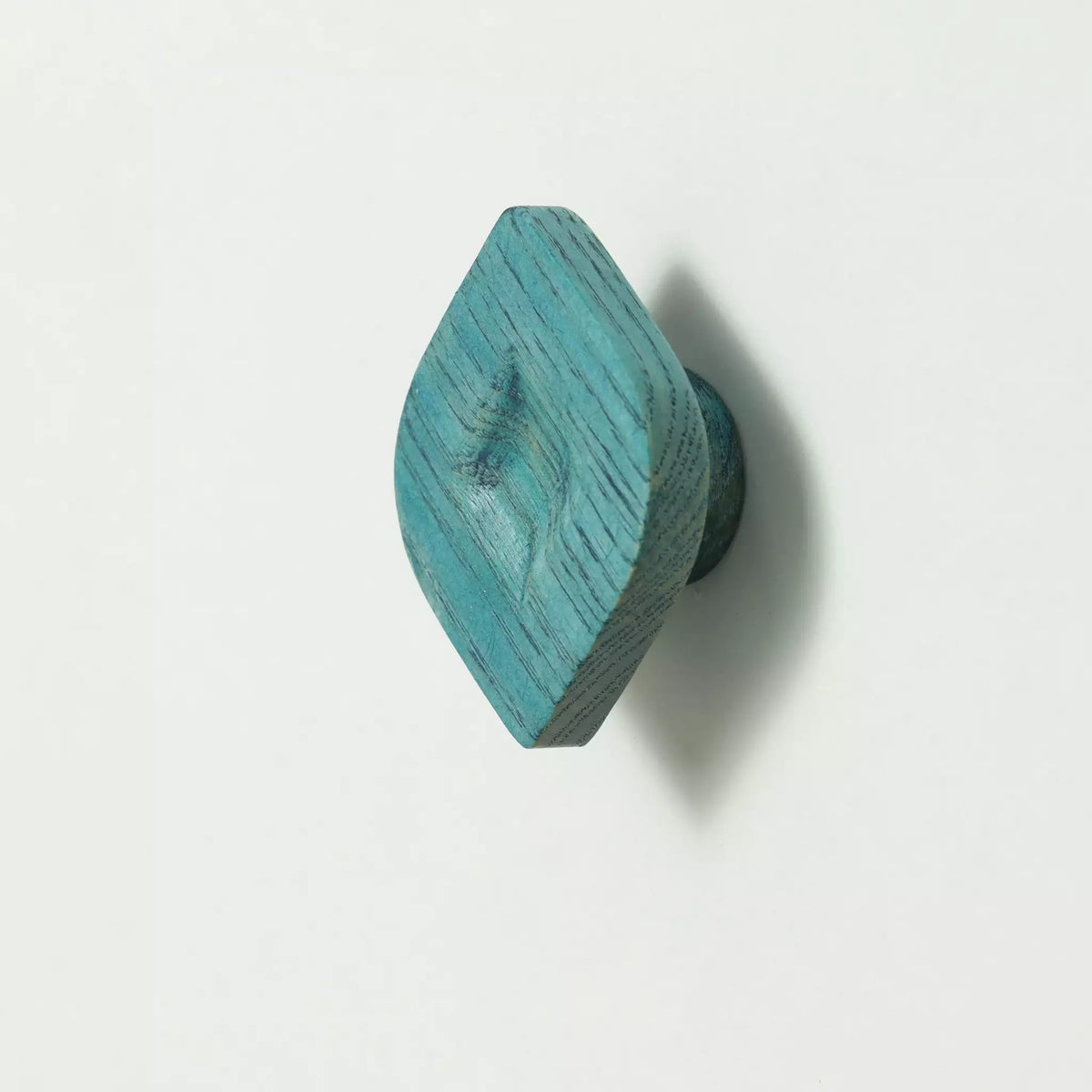 Twist cabinet knob in the Blue finish seen at an angle from above, showing the carved hollow