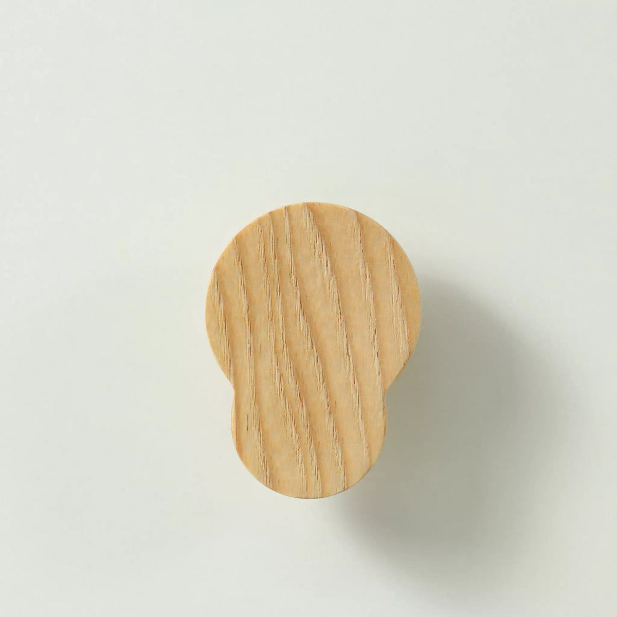 Unfinished solid ash double circle cabinet knob seen from the front, showing the flat face and the grain running across both circles