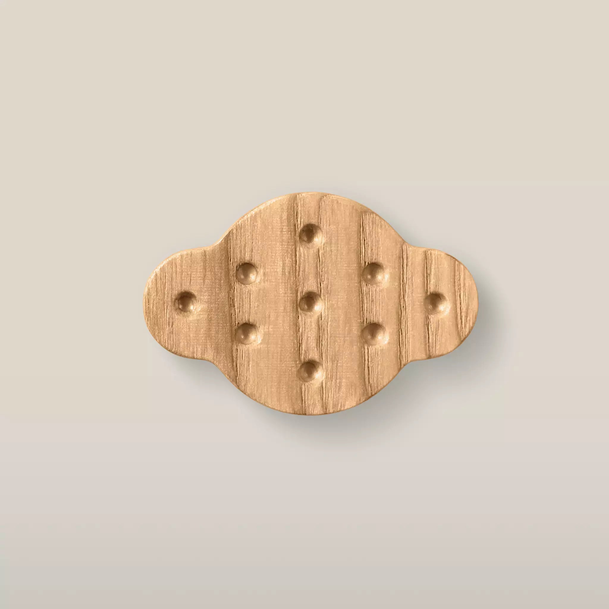 Solid ash dimpled oval cabinet knob in the Caffe Latte finish, front view