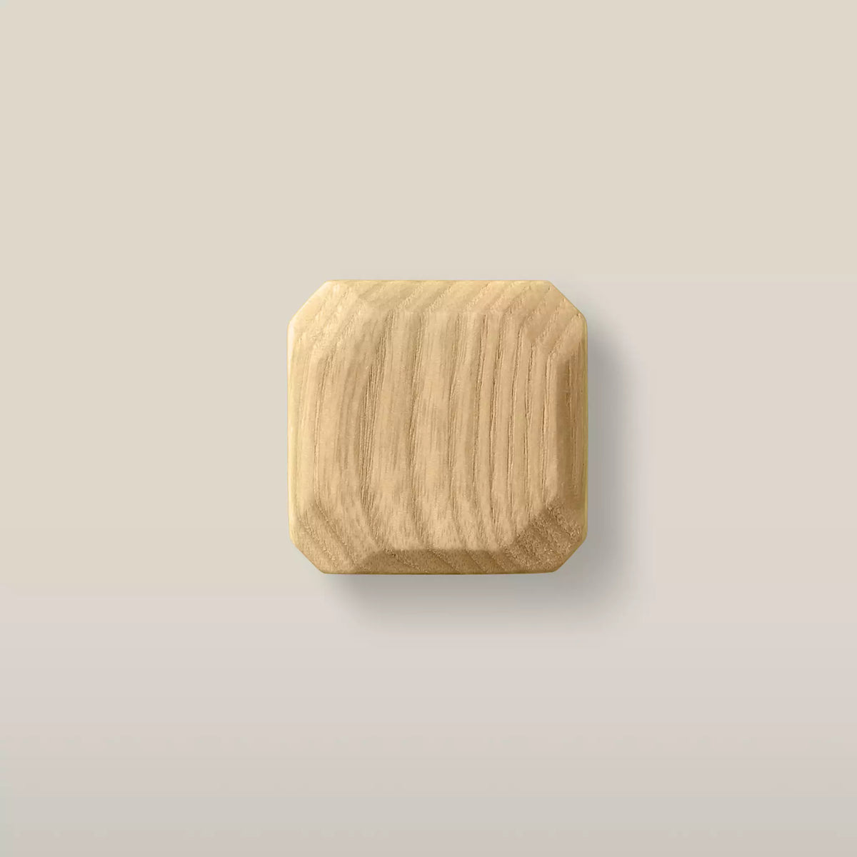 Octagonal ash cabinet knob, oiled — warm honey tone with the grain showing through