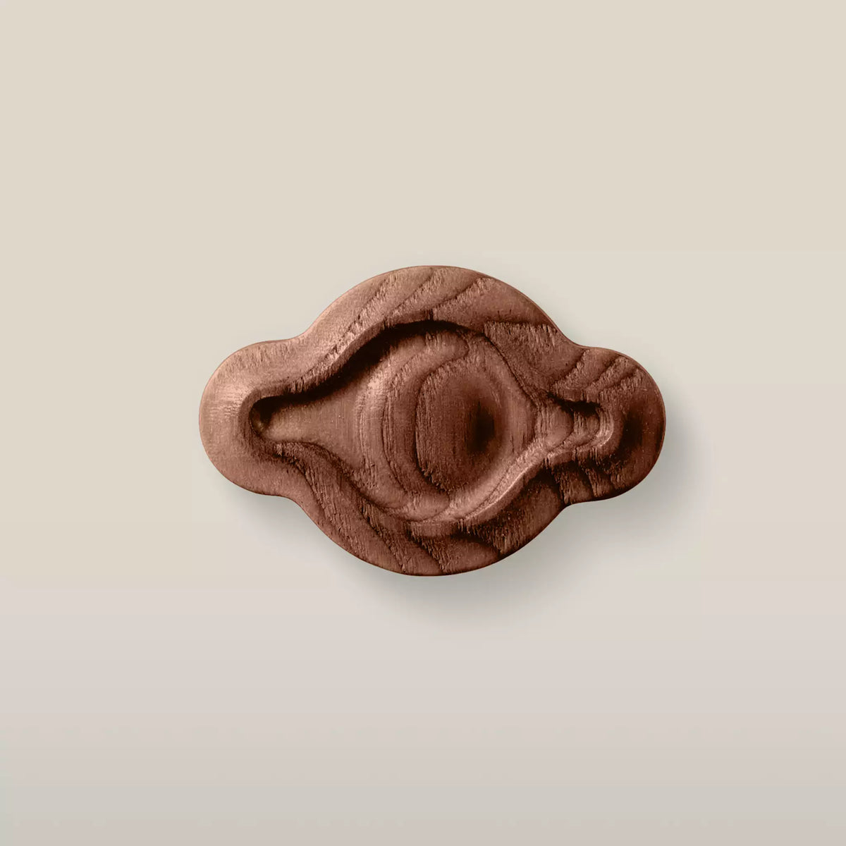 Solid ash petal cabinet knob in the Walnut finish, front view