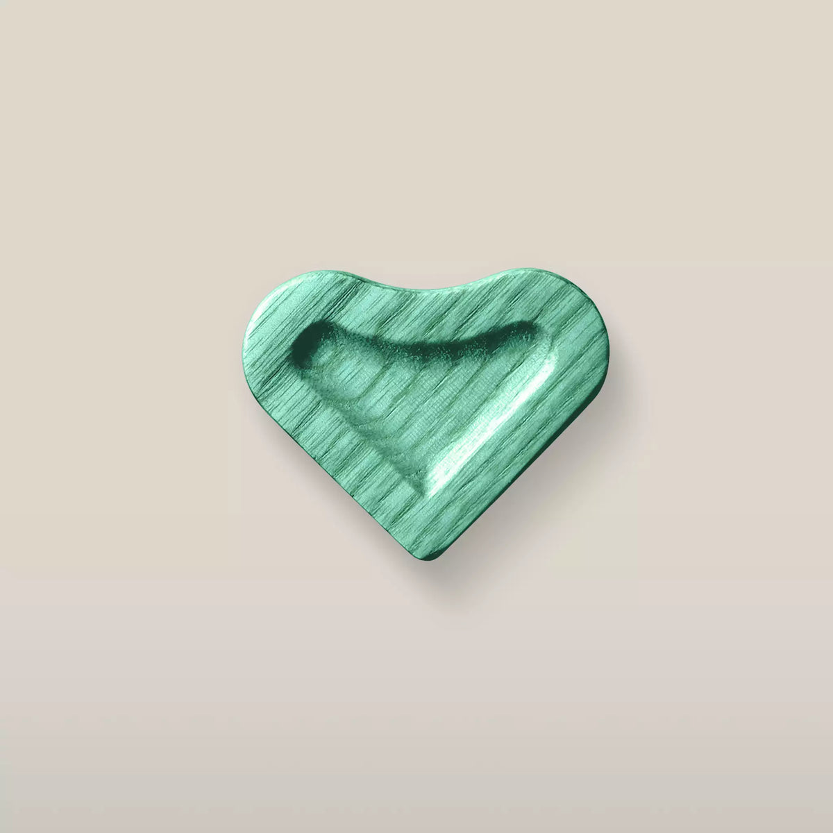 Solid ash scooped heart cabinet knob in the Green finish, front view