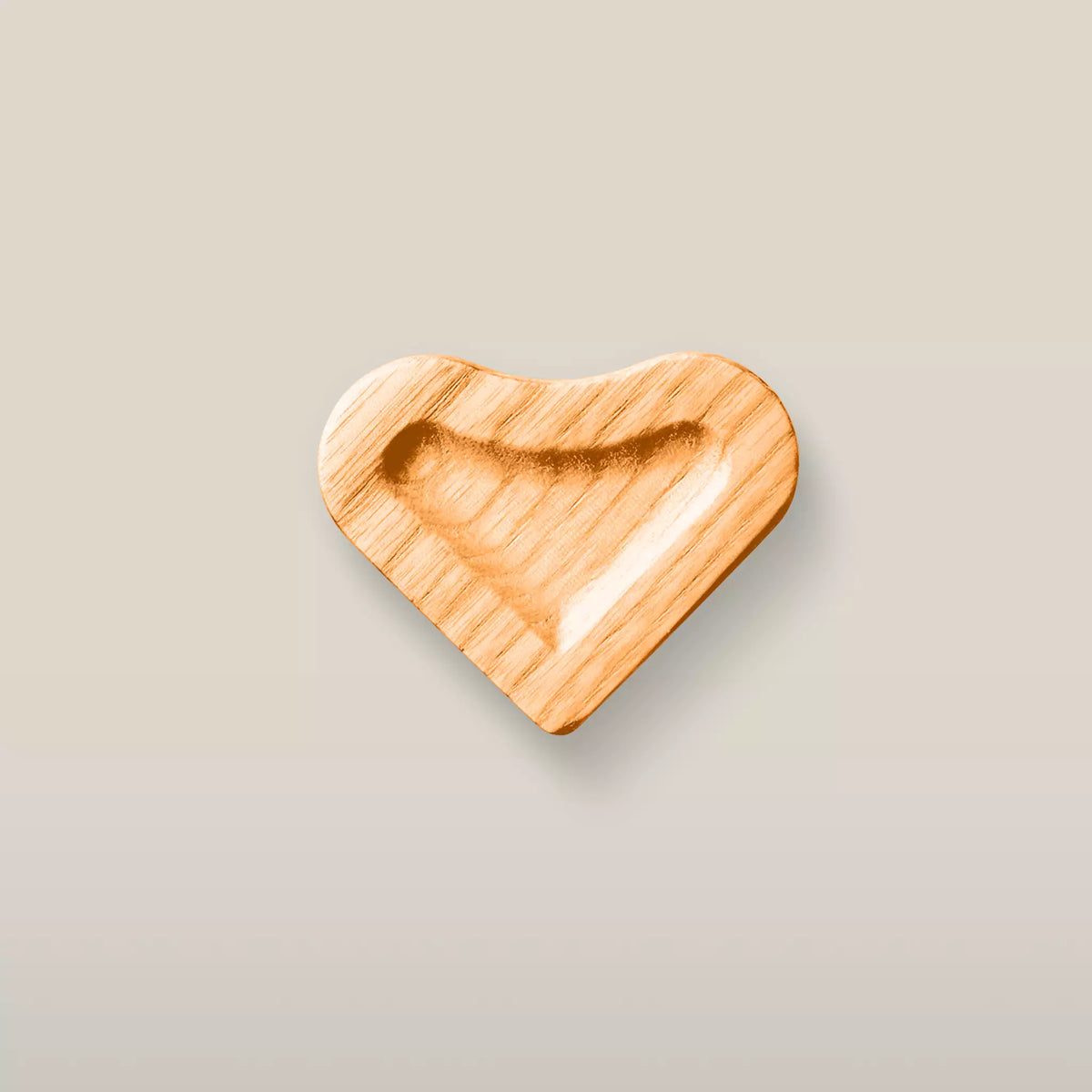 Solid ash scooped heart cabinet knob in the Orange finish, front view