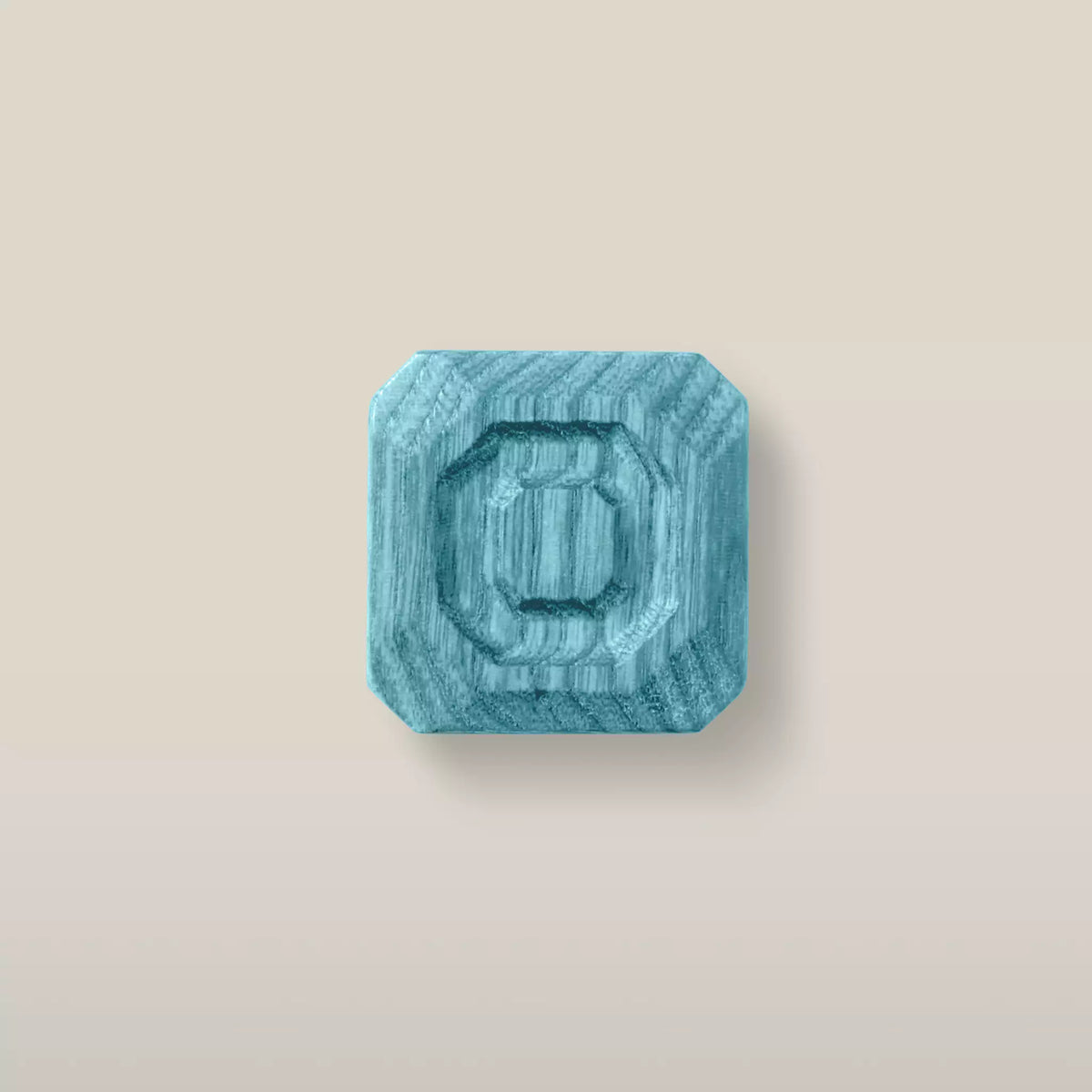 Solid ash stepped octagon cabinet knob in the Blue finish, front view