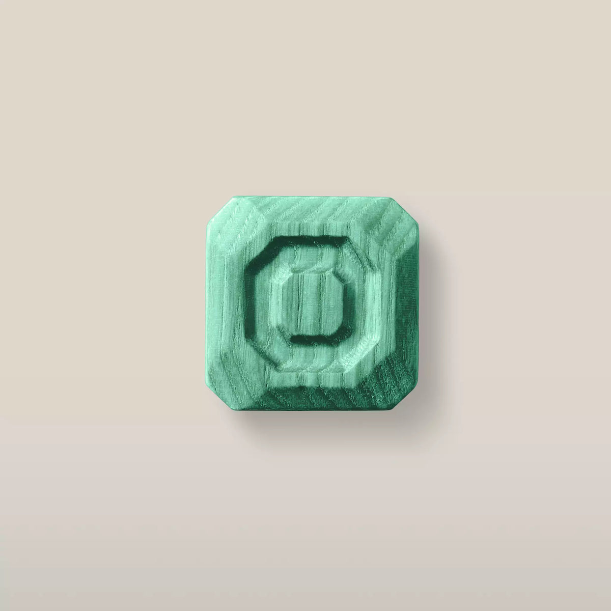 Solid ash stepped octagon cabinet knob in the Green finish, front view