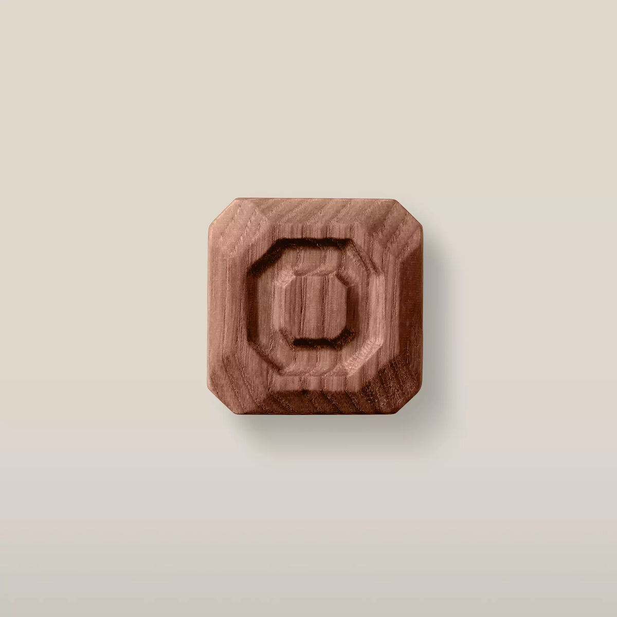 Solid ash stepped octagon cabinet knob in the Walnut finish, front view