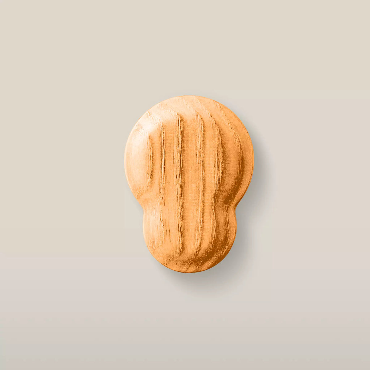 Solid ash fluted cabinet knob in the Orange finish, front view