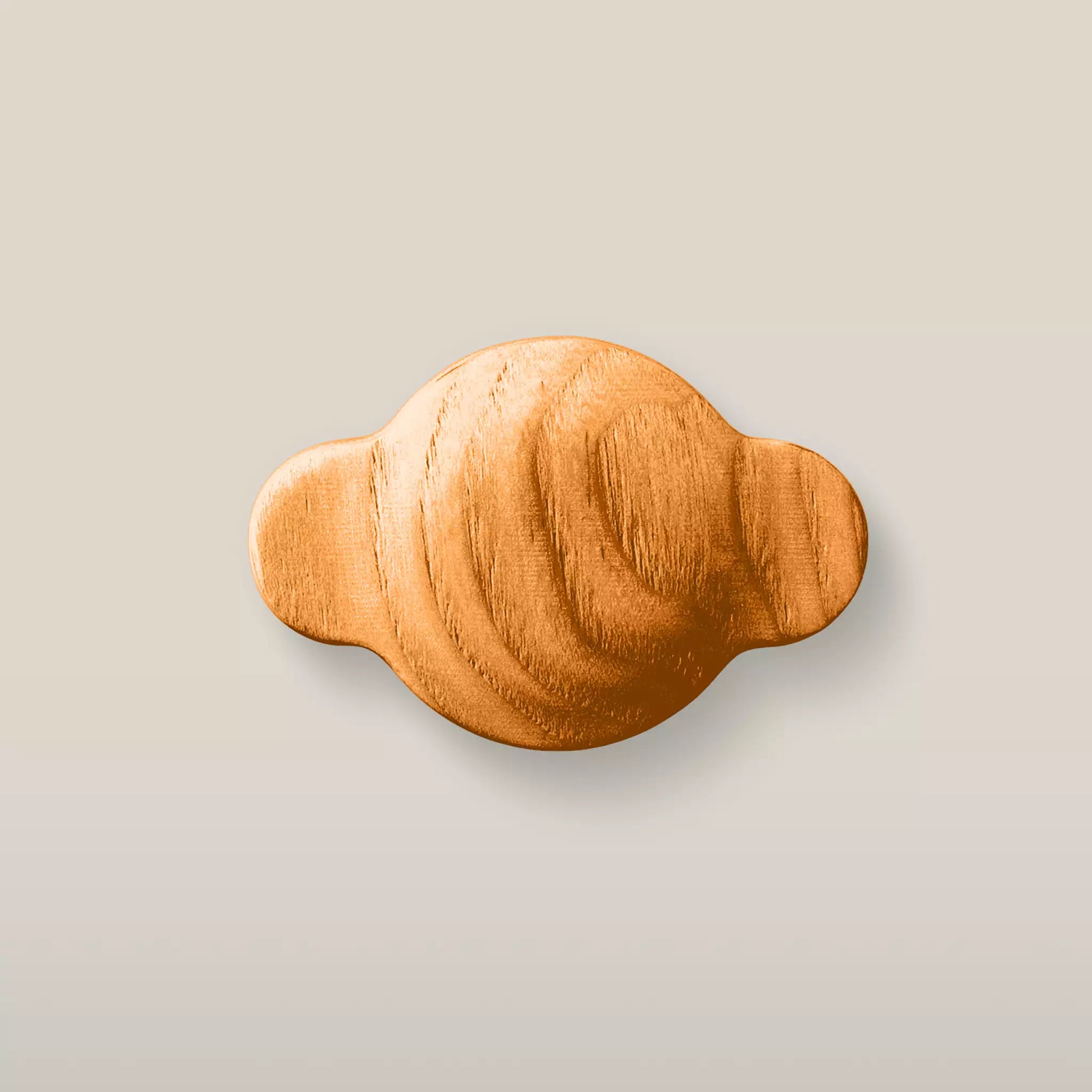 Solid ash wave cabinet knob in the Orange finish, front view
