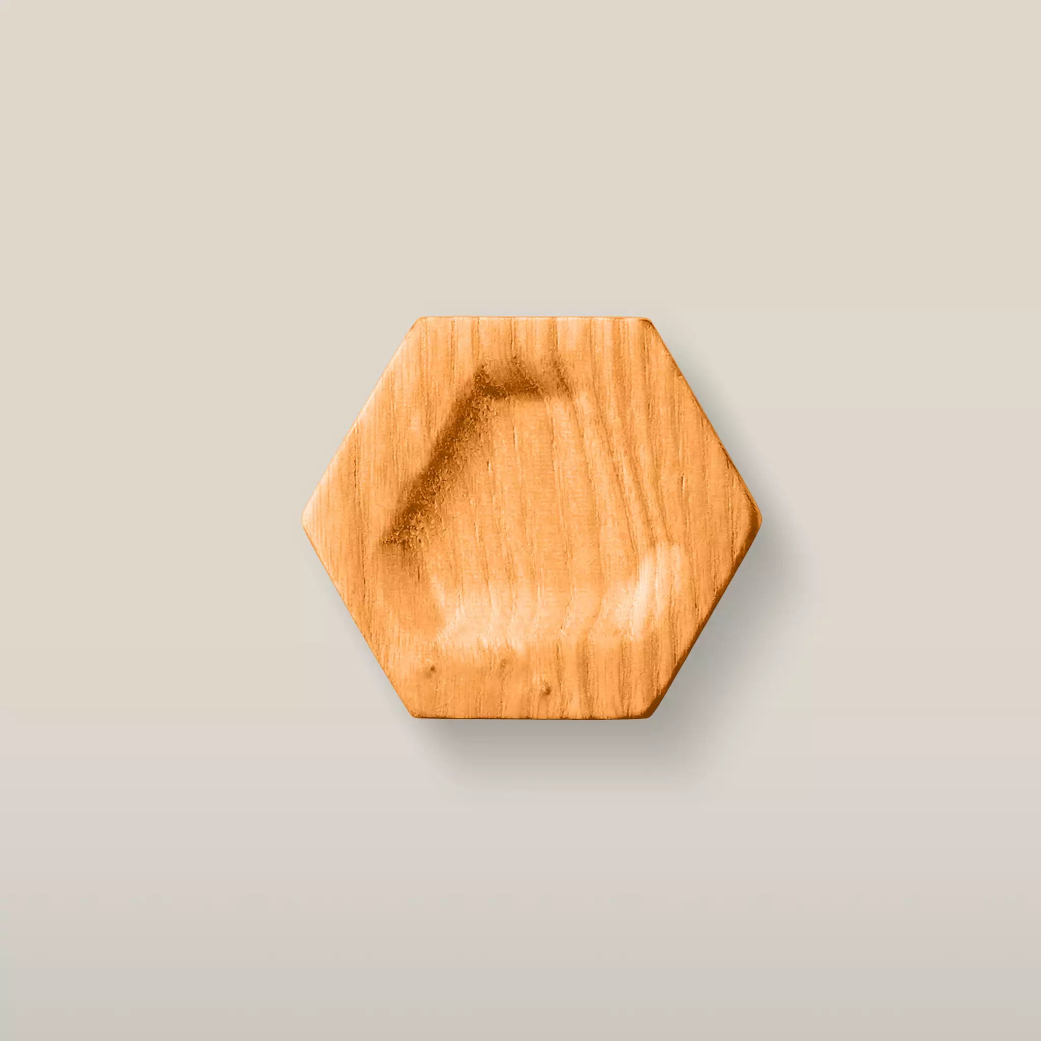 Solid ash carved hexagon cabinet knob in the Orange finish, front view