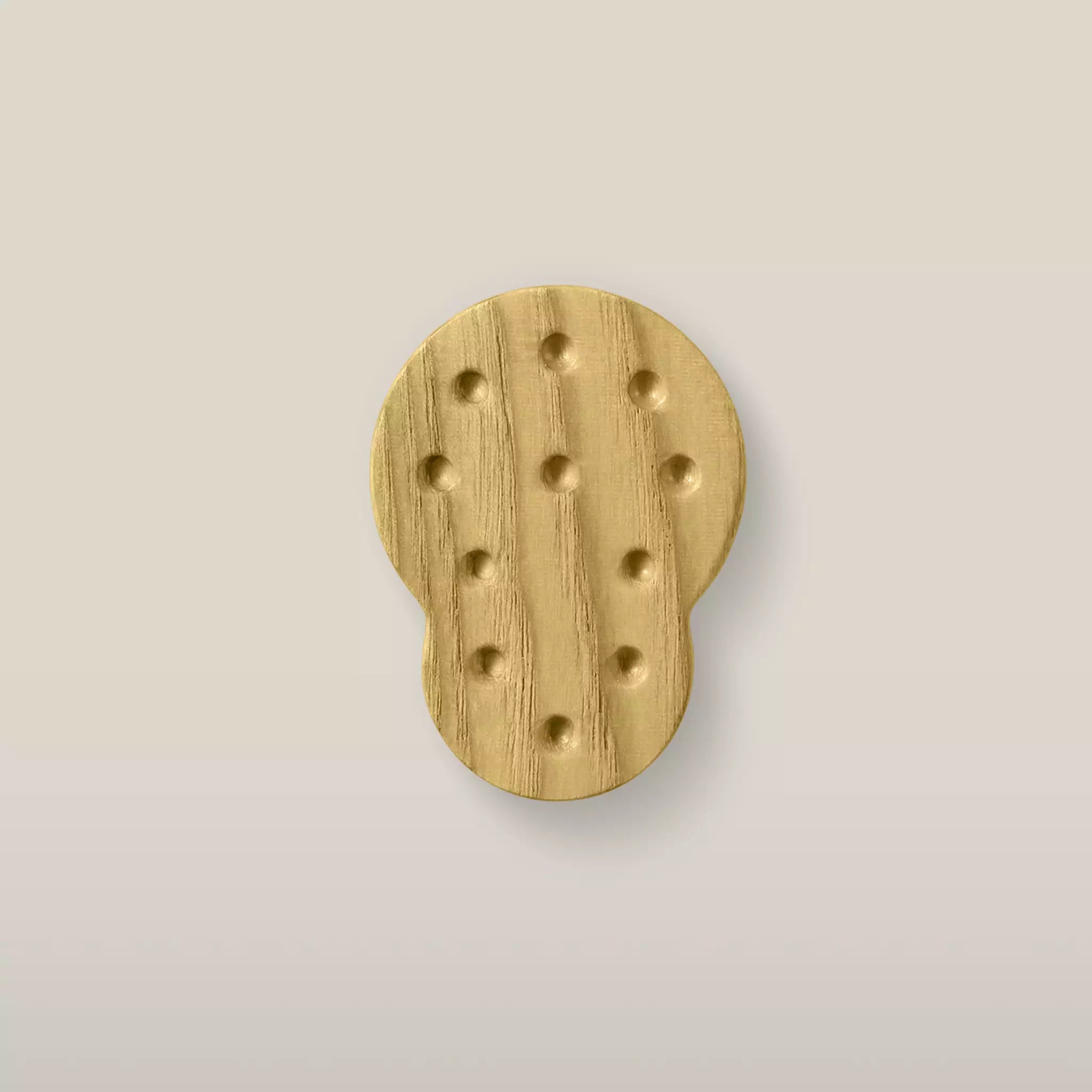 Solid ash dotted cabinet knob in the Cream finish, front view