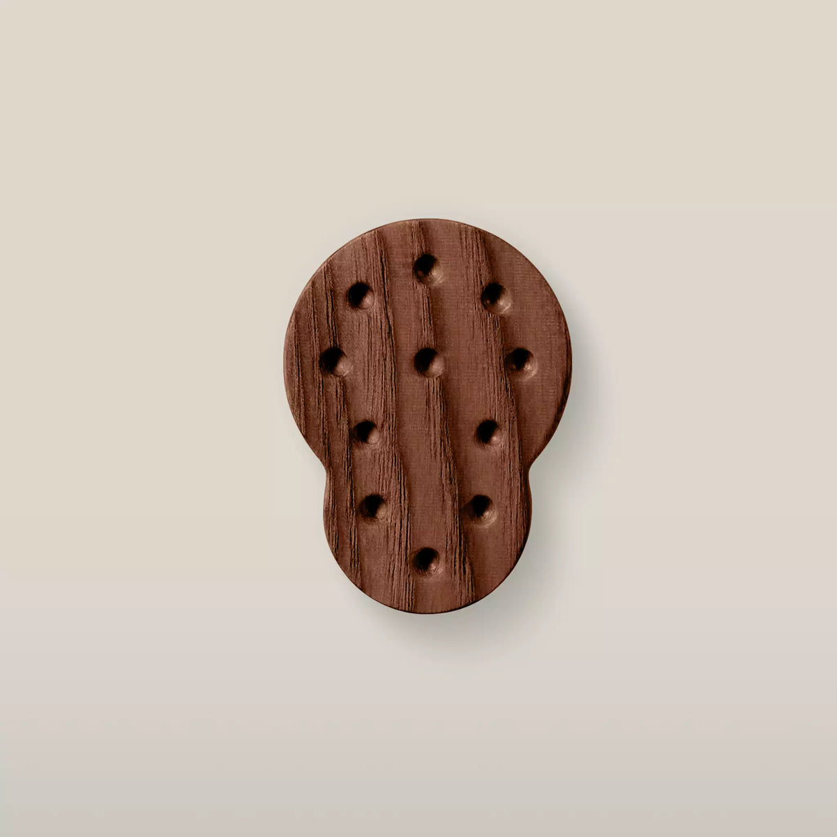 Solid ash dotted cabinet knob in the Walnut finish, front view