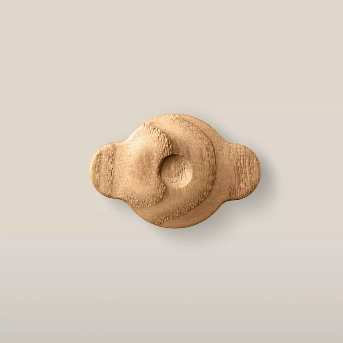 Solid ash swirl cabinet knob in the Caffe Latte finish, front view