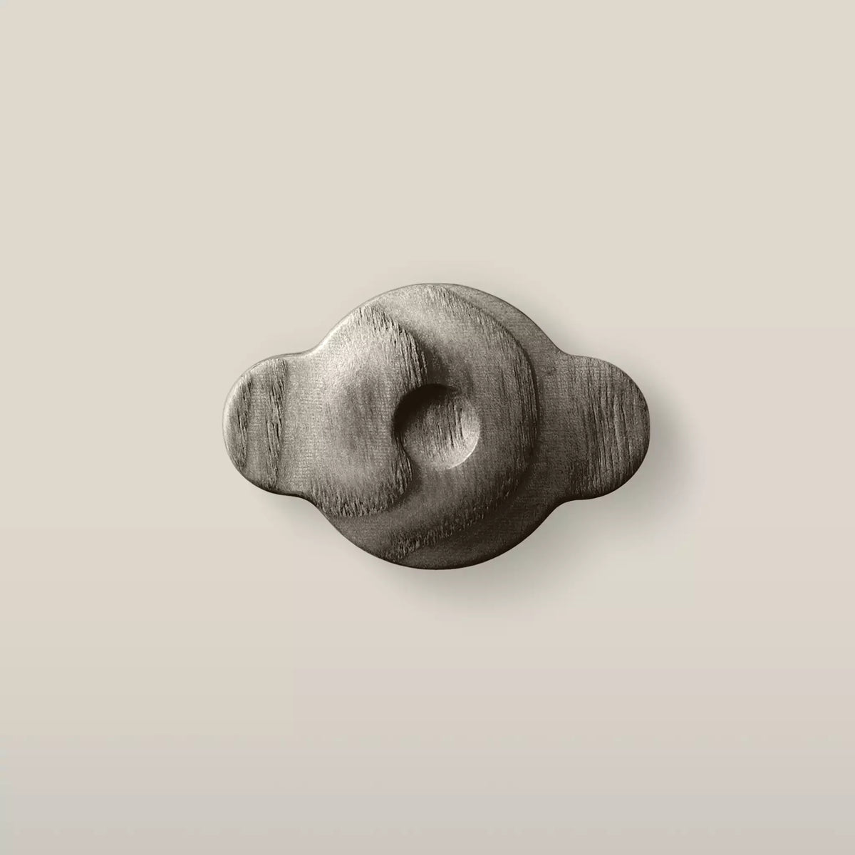 Solid ash swirl cabinet knob in the Dark Gray finish, front view