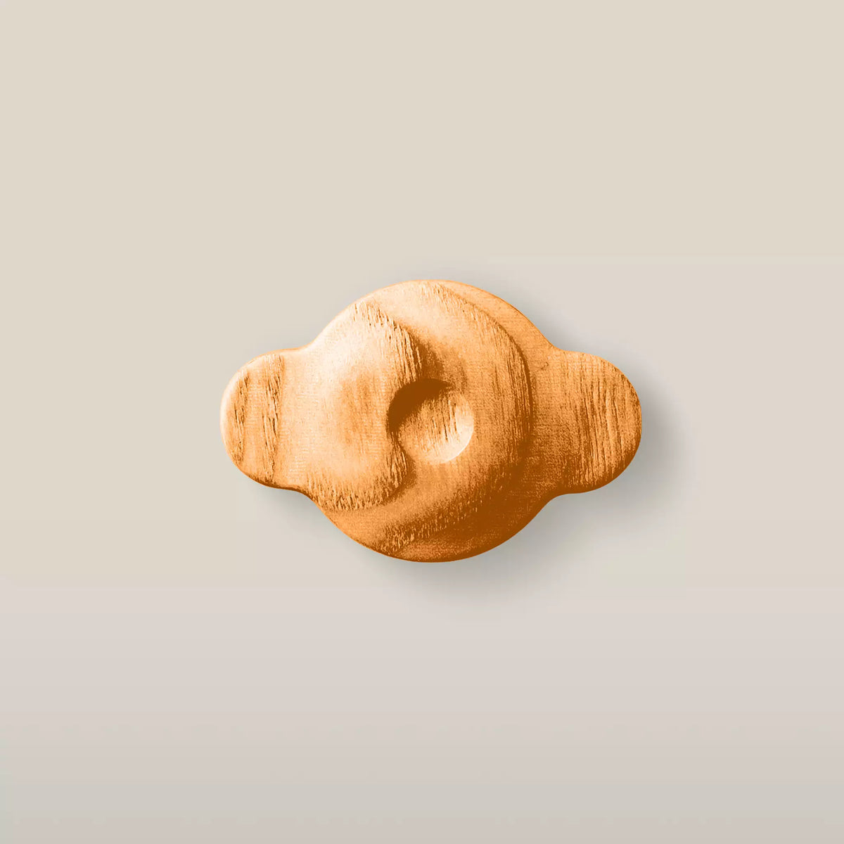 Solid ash swirl cabinet knob in the Orange finish, front view
