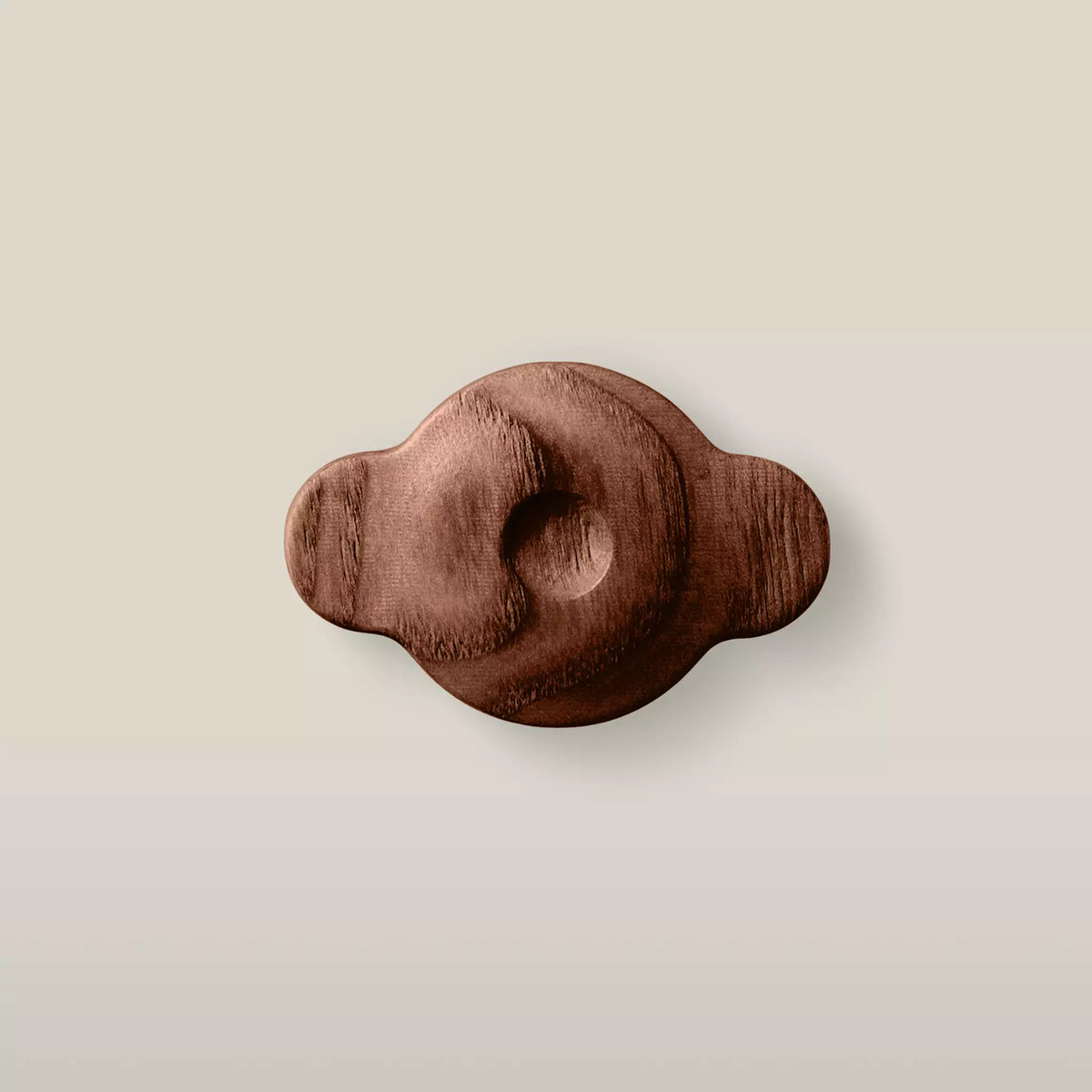 Solid ash swirl cabinet knob in the Walnut finish, front view