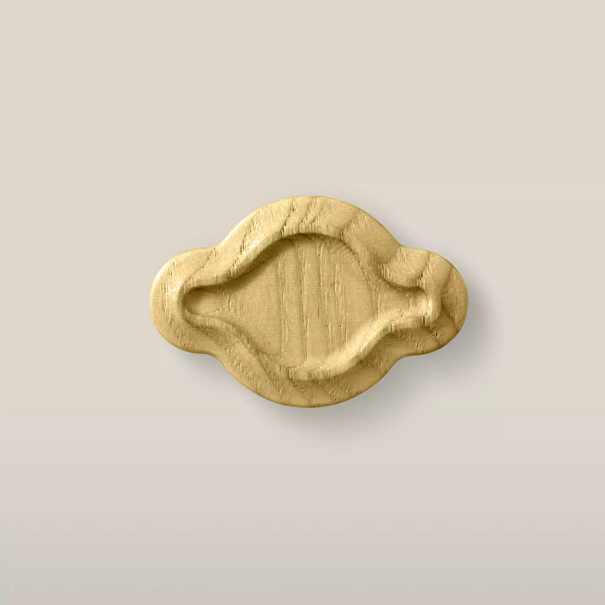 Solid ash scalloped oval cabinet knob in the Cream finish, front view