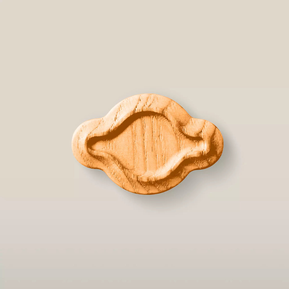 Solid ash scalloped oval cabinet knob in the Orange finish, front view