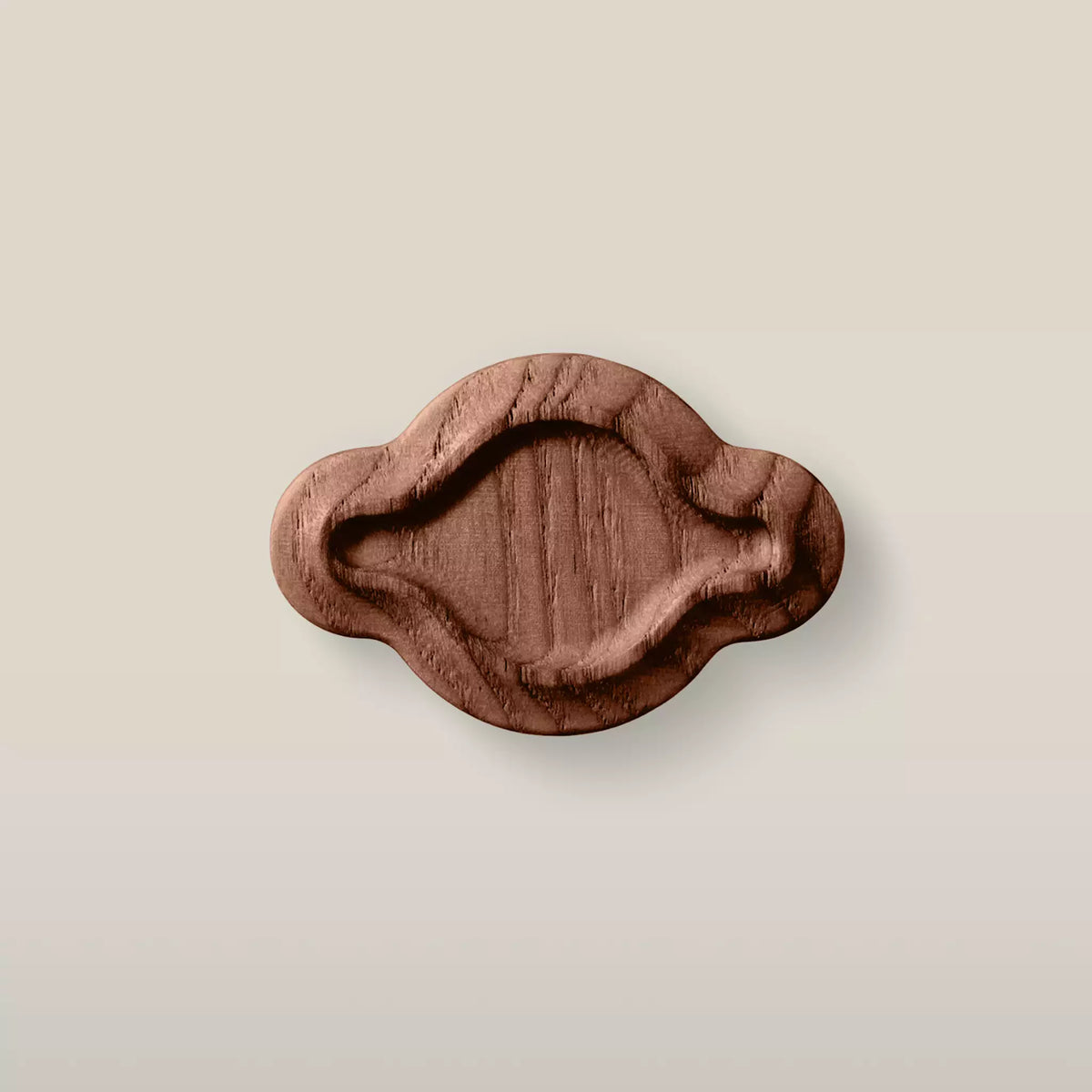 Solid ash scalloped oval cabinet knob in the Walnut finish, front view