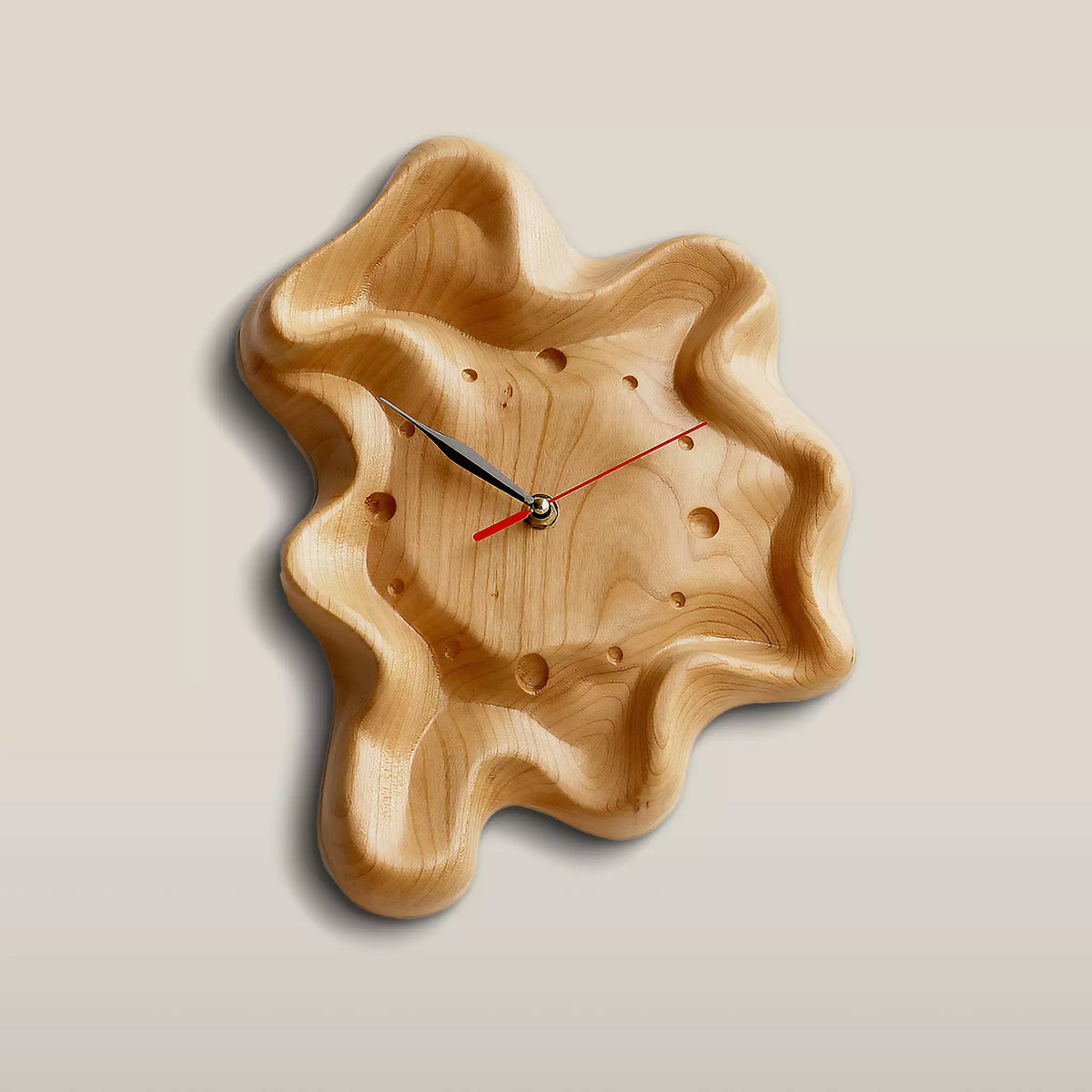 Wall clock with a hollowed face and rippled rim, hanging on a pale wall