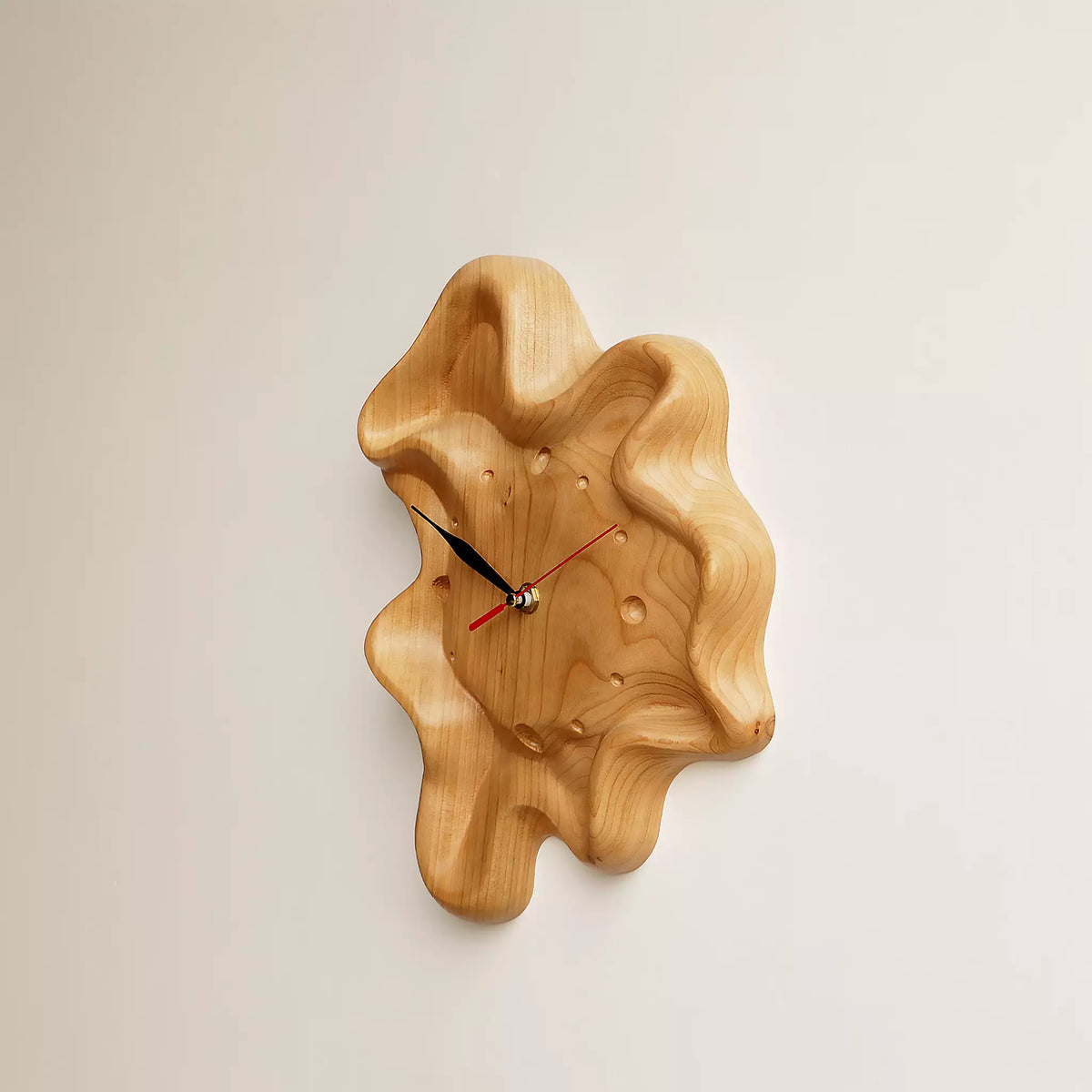 The clock seen straight on, with the irregular outline against the wall